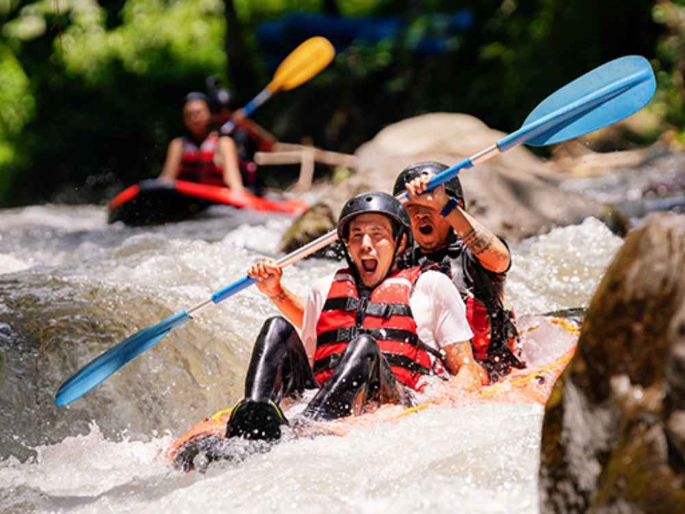 Couple enjoying a safe and guided kayaking experience in the jungle of Ubud.