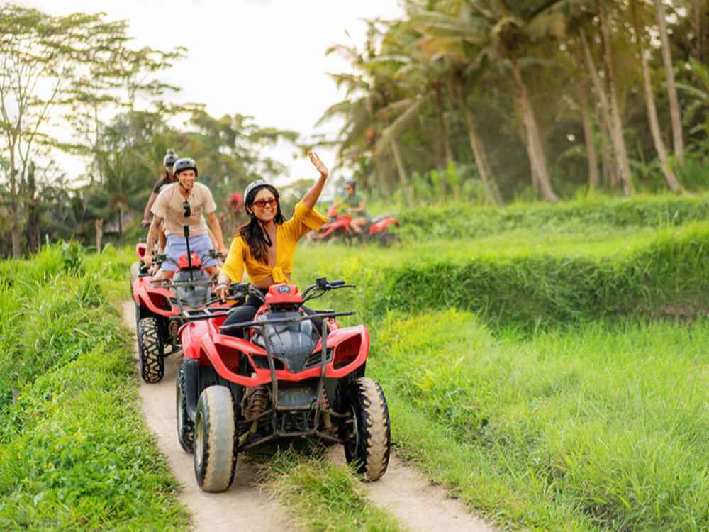 Riding a quad bike on a muddy track during an ATV tour in Ubud.
