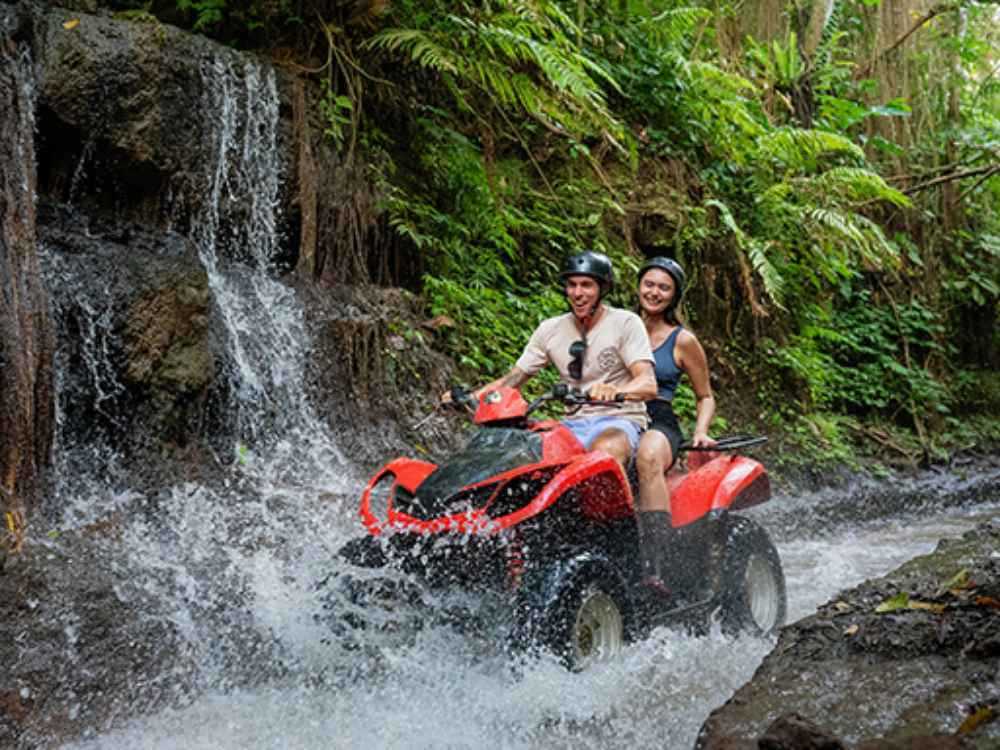 Couple riding a tandem ATV exploring the scenic outdoor routes of Bali.